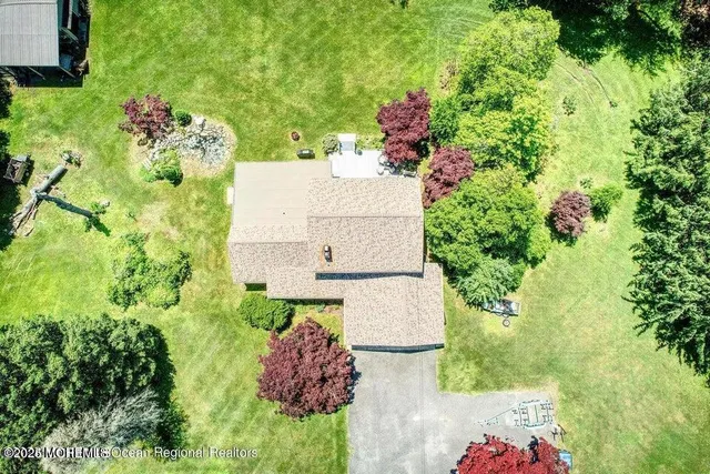 an aerial view of a house with a yard and garden
