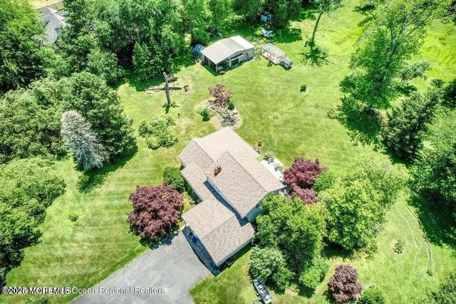 an aerial view of a house with a yard and garden