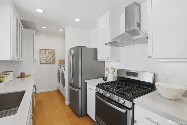 a kitchen with stainless steel appliances granite countertop a refrigerator and a sink