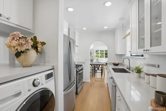 a view of a kitchen with furniture and wooden floor