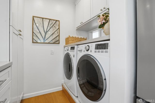 a close view of a utility room with dryer and washer