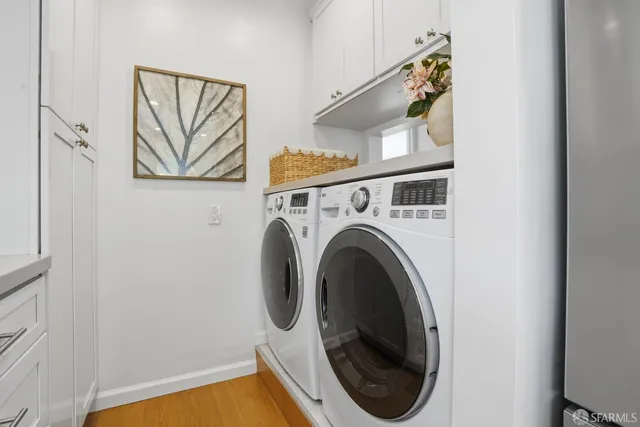 a close view of a utility room with dryer and washer