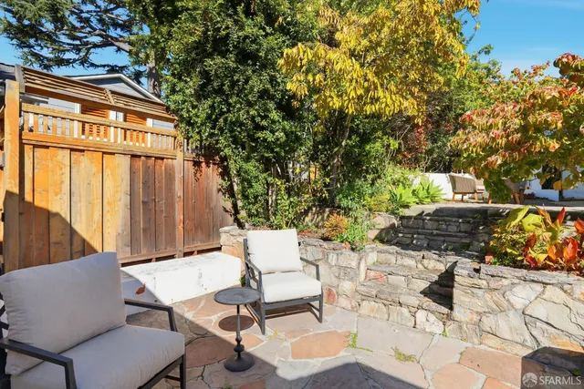 a backyard of a house with table and chairs