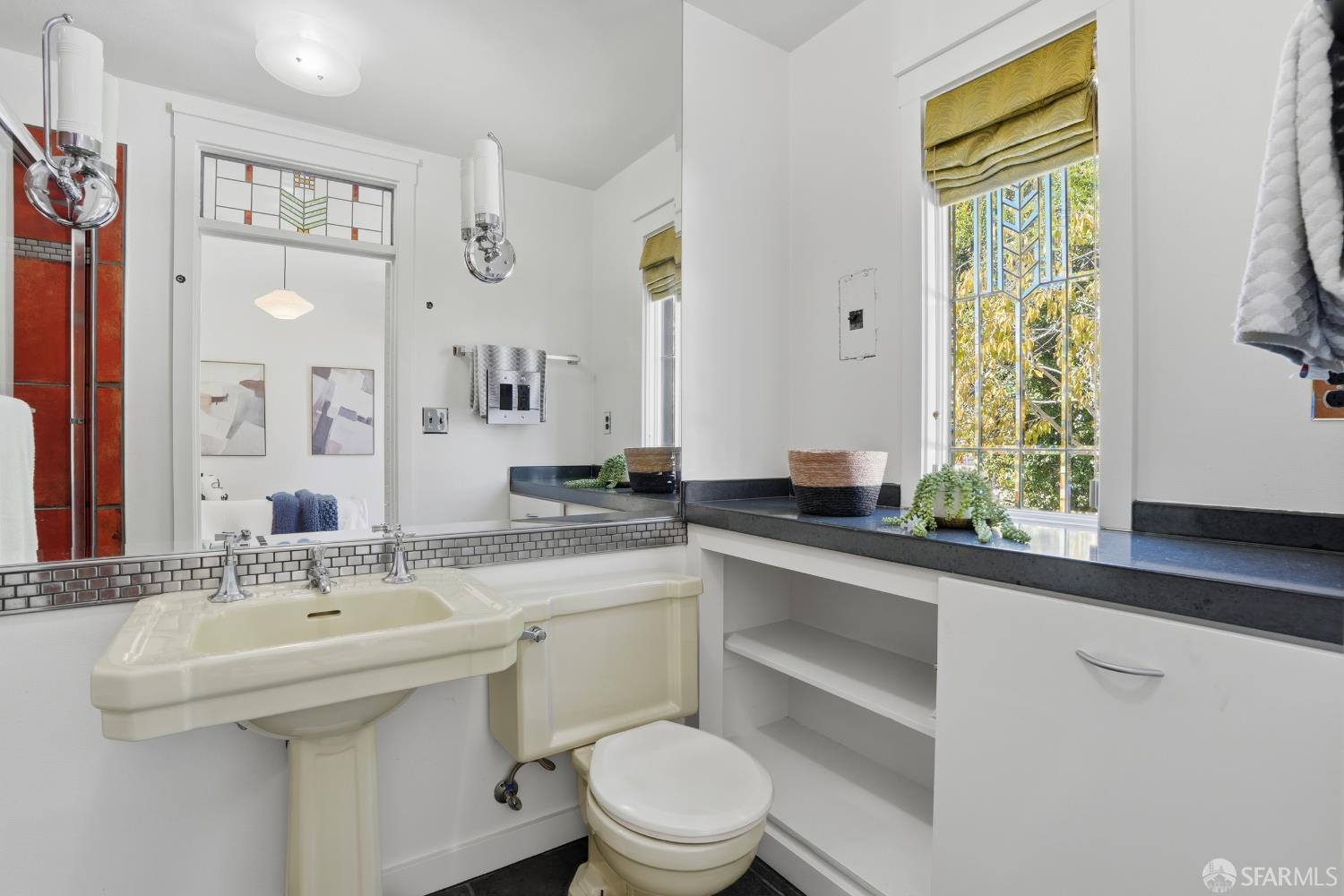 4614 Jacobus Avenue Oakland, CA 94618 - Photo 33 of 40 a bathroom with a sink a toilet and a mirror
