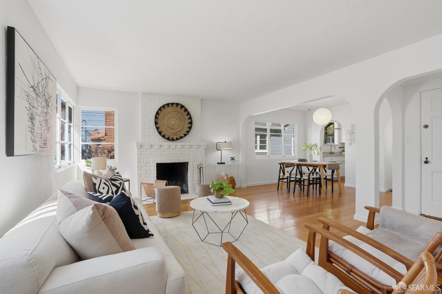 4614 Jacobus Avenue Oakland, CA 94618 - Photo 10 of 40 a living room with furniture a fireplace a clock and a view of kitchen