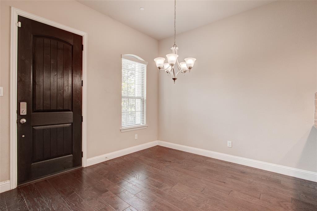 6156 Rilla Street Frisco, TX 75035 - Photo 2 of 32 an empty room with wooden floor chandelier and windows