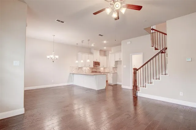a view of a livingroom and a chandelier fan