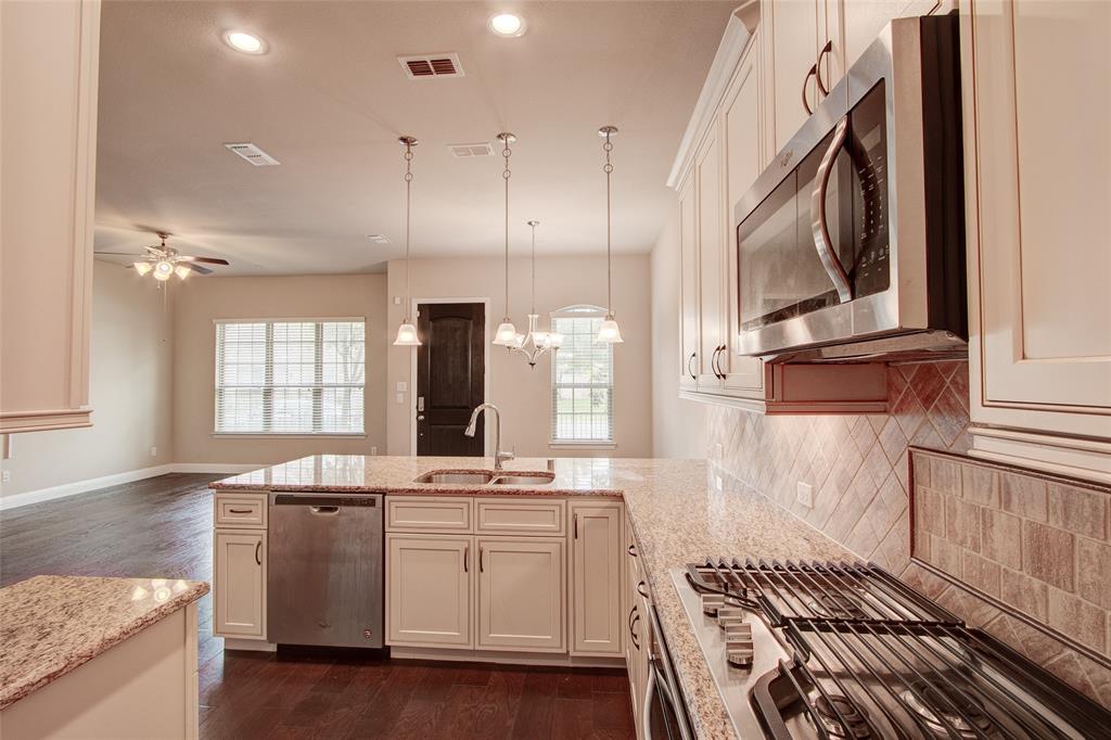 6156 Rilla Street Frisco, TX 75035 - Photo 25 of 32 a kitchen with a sink stove and cabinets