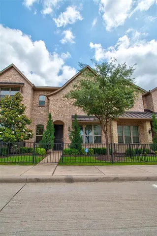 front view of a house with potted plants