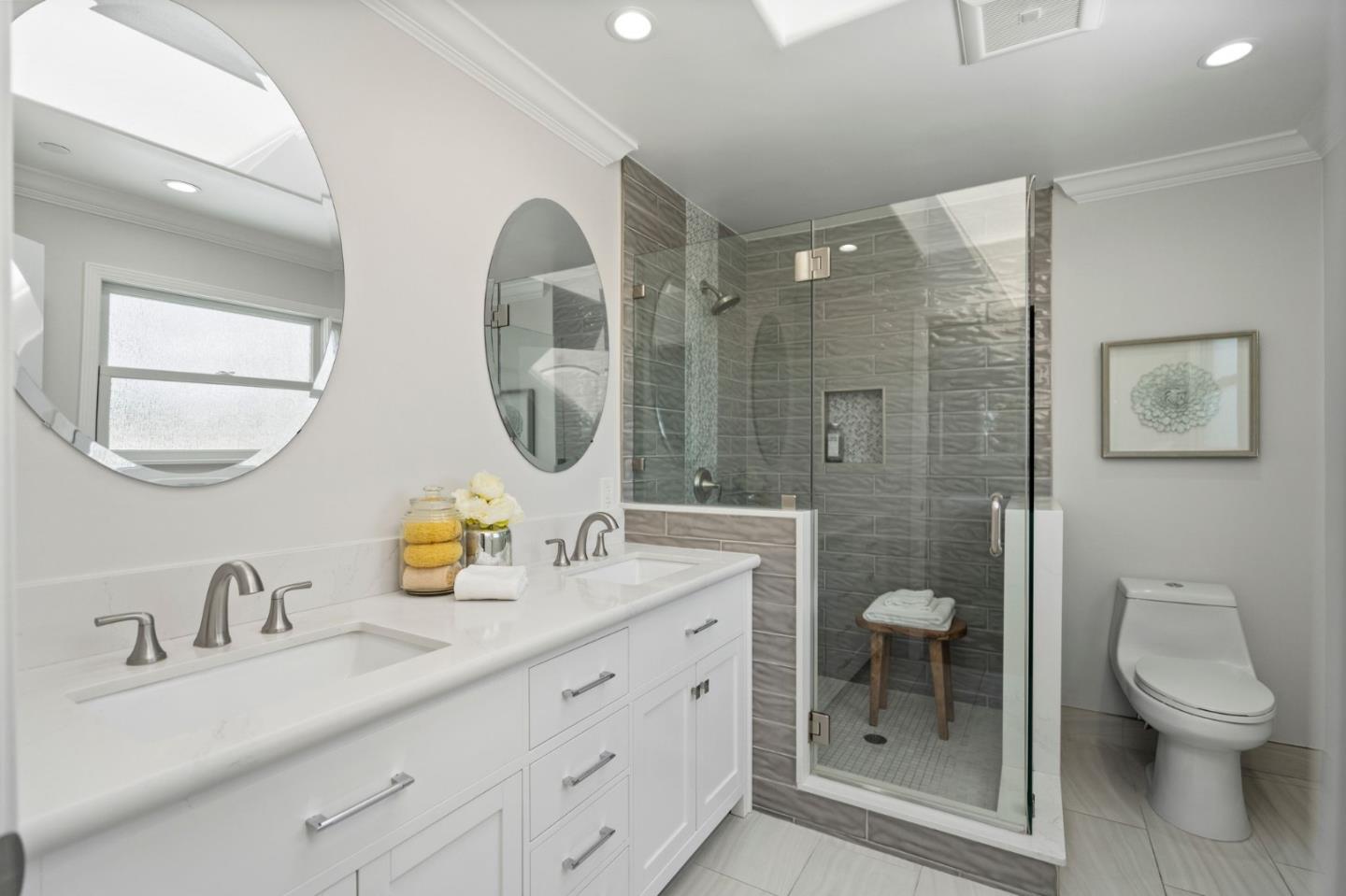 511 Corbitt Drive Burlingame, CA 94010 - Photo 26 of 43 a bathroom with a granite countertop toilet a sink a mirror and a shower