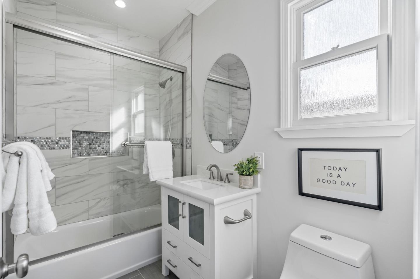 511 Corbitt Drive Burlingame, CA 94010 - Photo 29 of 43 a bathroom with a sink a mirror and a shower