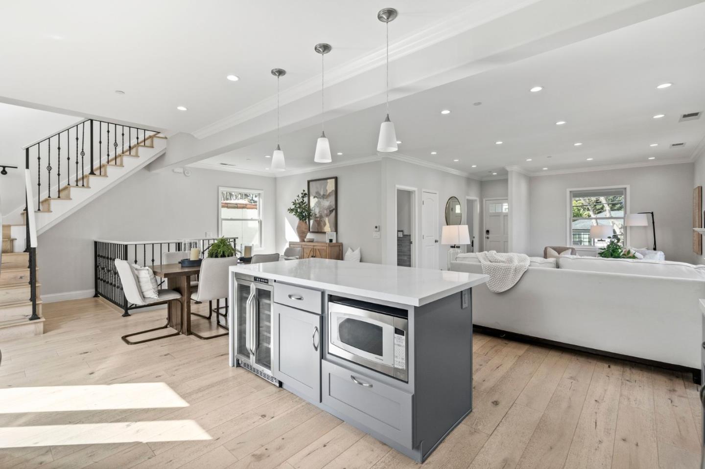 511 Corbitt Drive Burlingame, CA 94010 - Photo 10 of 43 a large white kitchen with a white countertops a stove a dining table and chairs with wooden floor