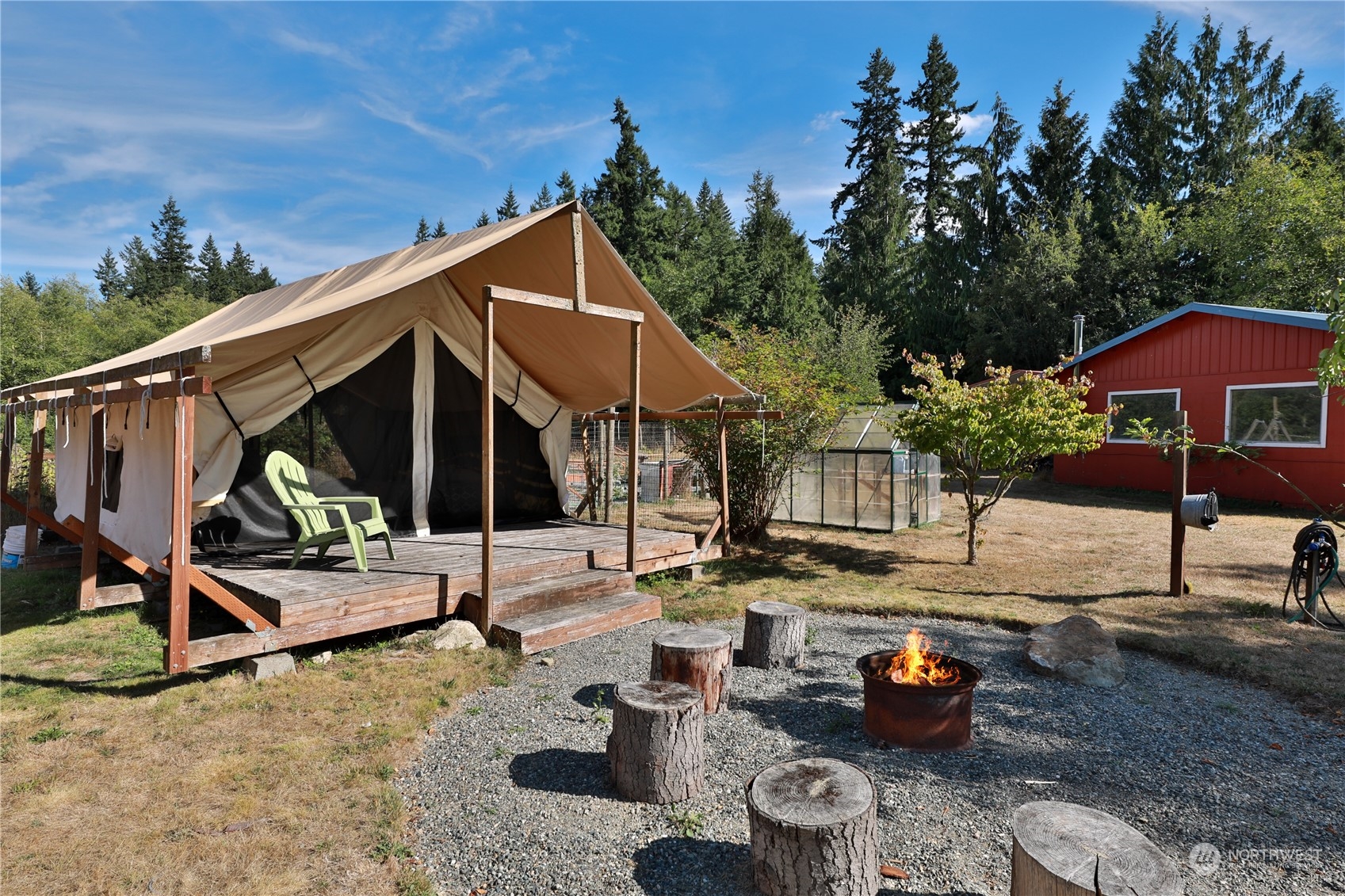 5493 Langley Road Langley, WA 98260 - Photo 25 of 36 a backyard of a house with barbeque oven table and chairs