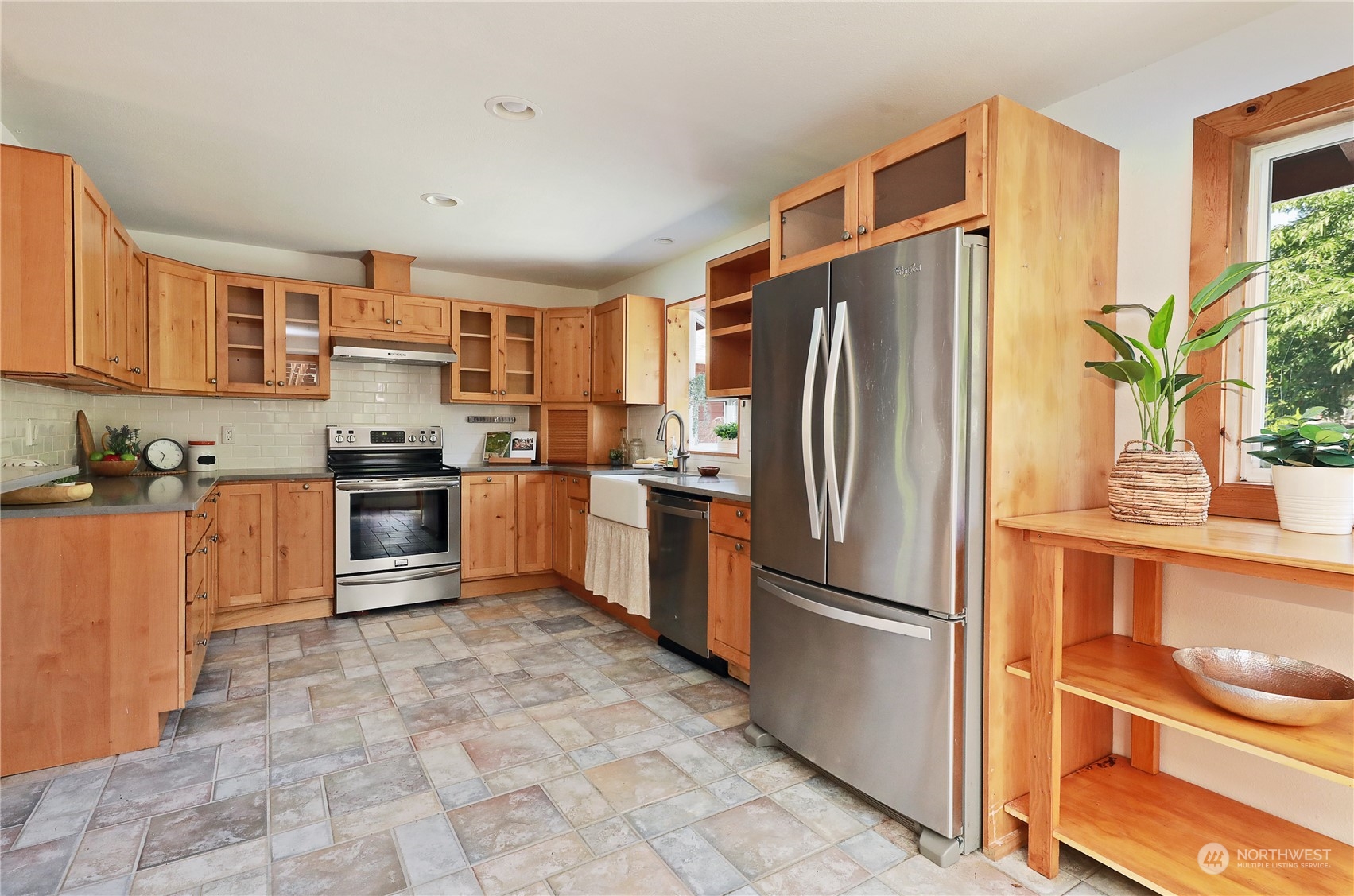 5493 Langley Road Langley, WA 98260 - Photo 9 of 36 a kitchen with stainless steel appliances granite countertop a refrigerator a stove and a sink