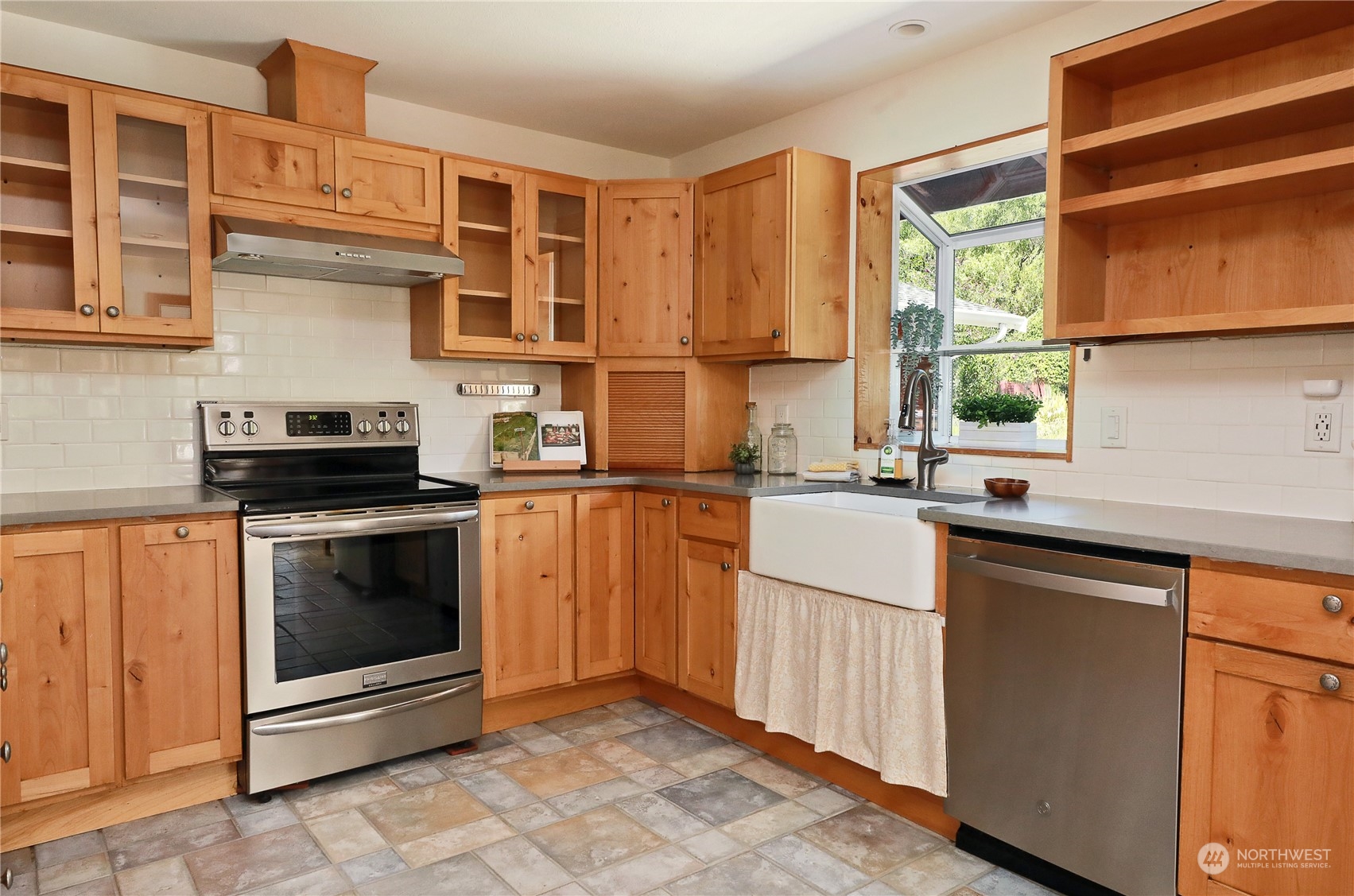 5493 Langley Road Langley, WA 98260 - Photo 10 of 36 a kitchen with stainless steel appliances granite countertop a stove a sink and a microwave