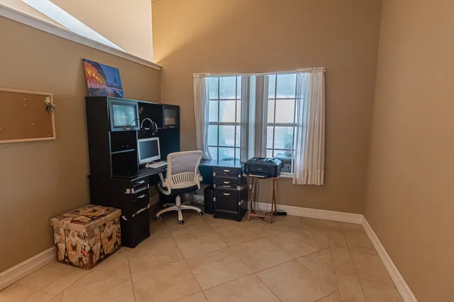 a spacious bedroom with a bed and a chandelier