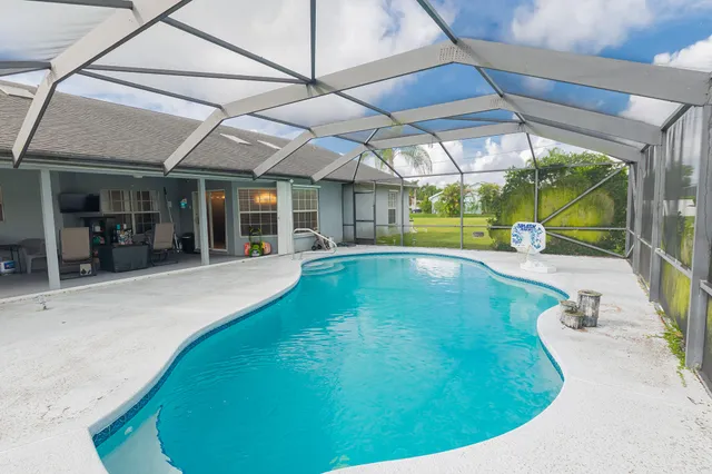 a view of a backyard with a swimming pool