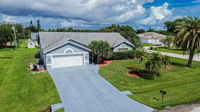 an aerial view of a house with a garden and trees