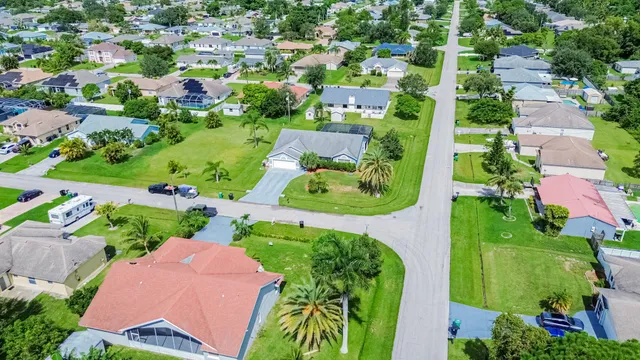 an aerial view of residential houses with outdoor space and street view