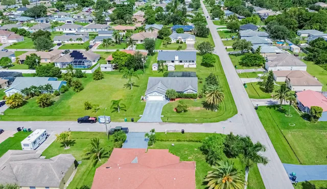 an aerial view of multiple houses with yard