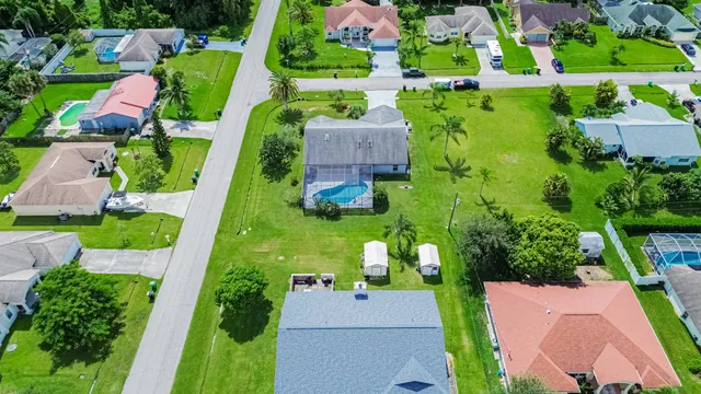 an aerial view of a house with a yard