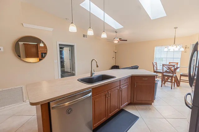 a kitchen that has a sink a stove and a table with chairs