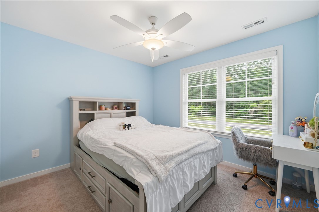 7598 Rural Point Road Mechanicsville, VA 23116 - Photo 31 of 41 a bedroom with a bed and a large window