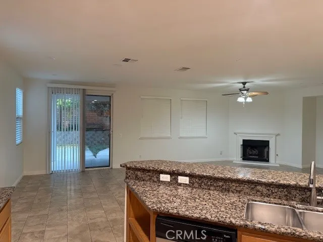 a living room with granite countertop furniture and a fireplace