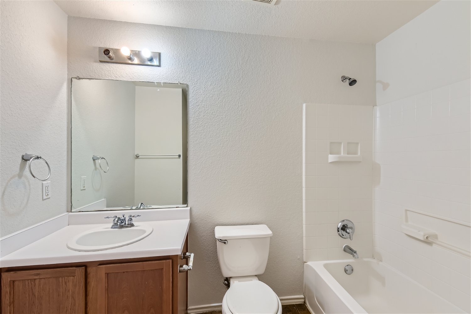 18408 Cloudmore Lane Elgin, TX 78621 - Photo 8 of 11 Functional full bathroom with a spacious vanity, toilet, and a tiled shower/tub combination.
