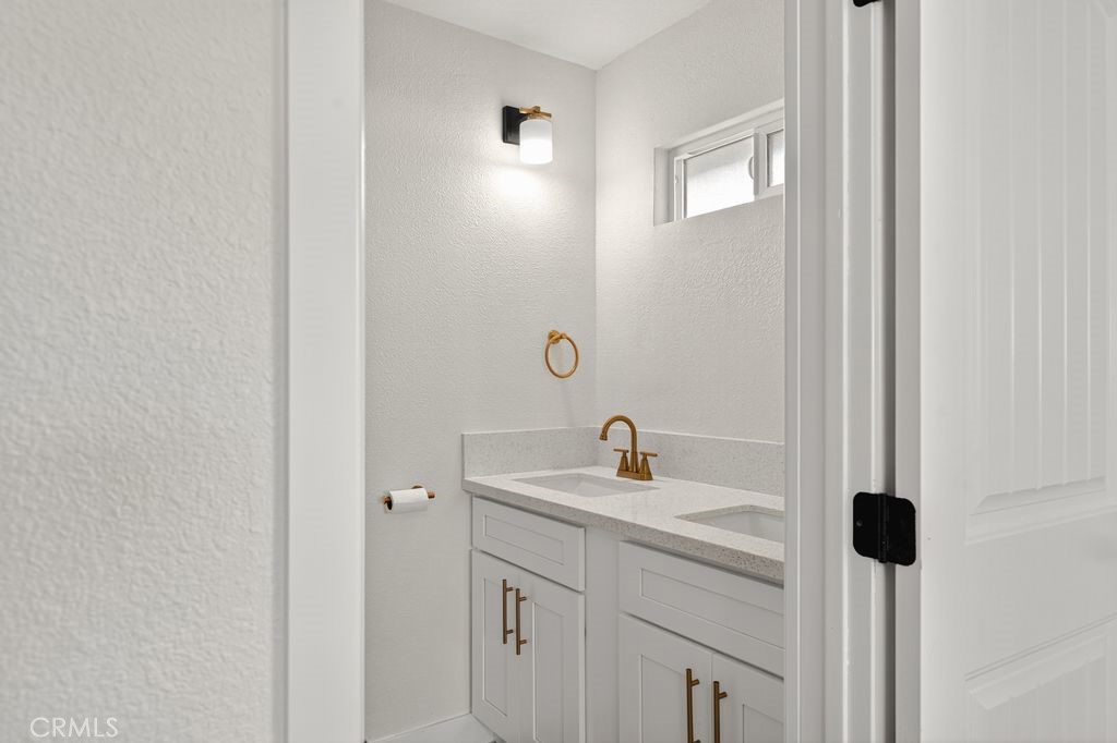 606 East Jackson Street Rialto, CA 92376 - Photo 17 of 29 a bathroom with a sink and a mirror