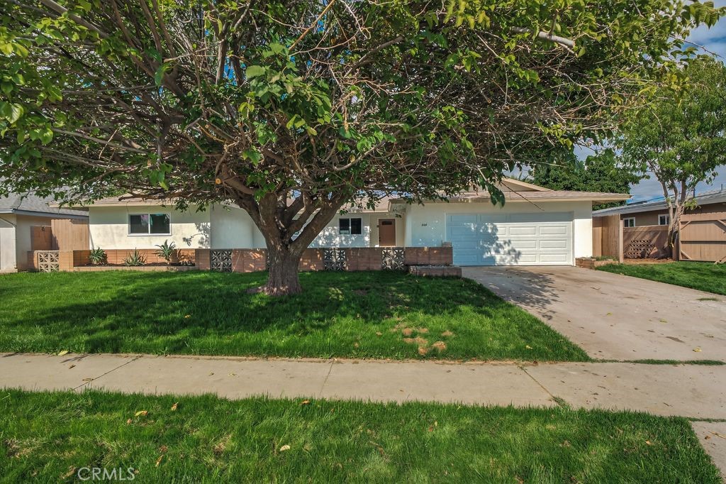 606 East Jackson Street Rialto, CA 92376 - Photo 29 of 29 a front view of a house with a yard and garage