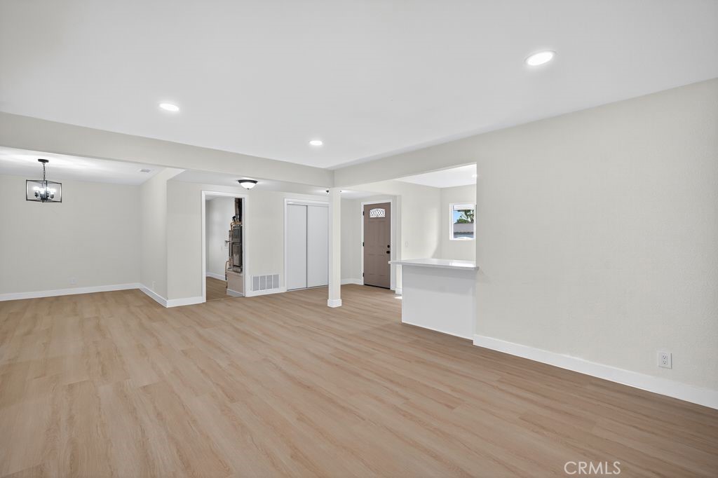 606 East Jackson Street Rialto, CA 92376 - Photo 3 of 29 a view of an empty room with wooden floor and a window