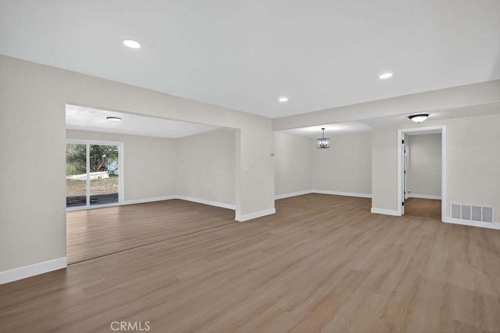 606 East Jackson Street Rialto, CA 92376 - Photo 4 of 29 a view of an empty room with wooden floor and a window