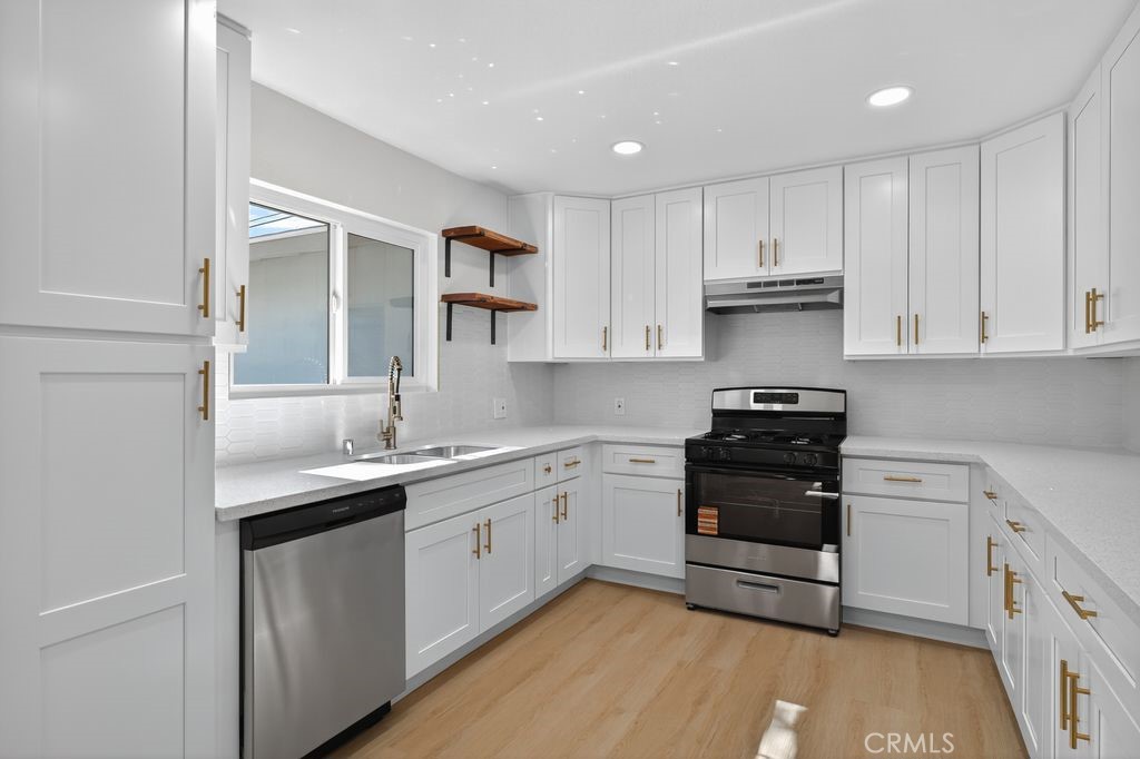 606 East Jackson Street Rialto, CA 92376 - Photo 9 of 29 a kitchen with a sink stove and cabinets