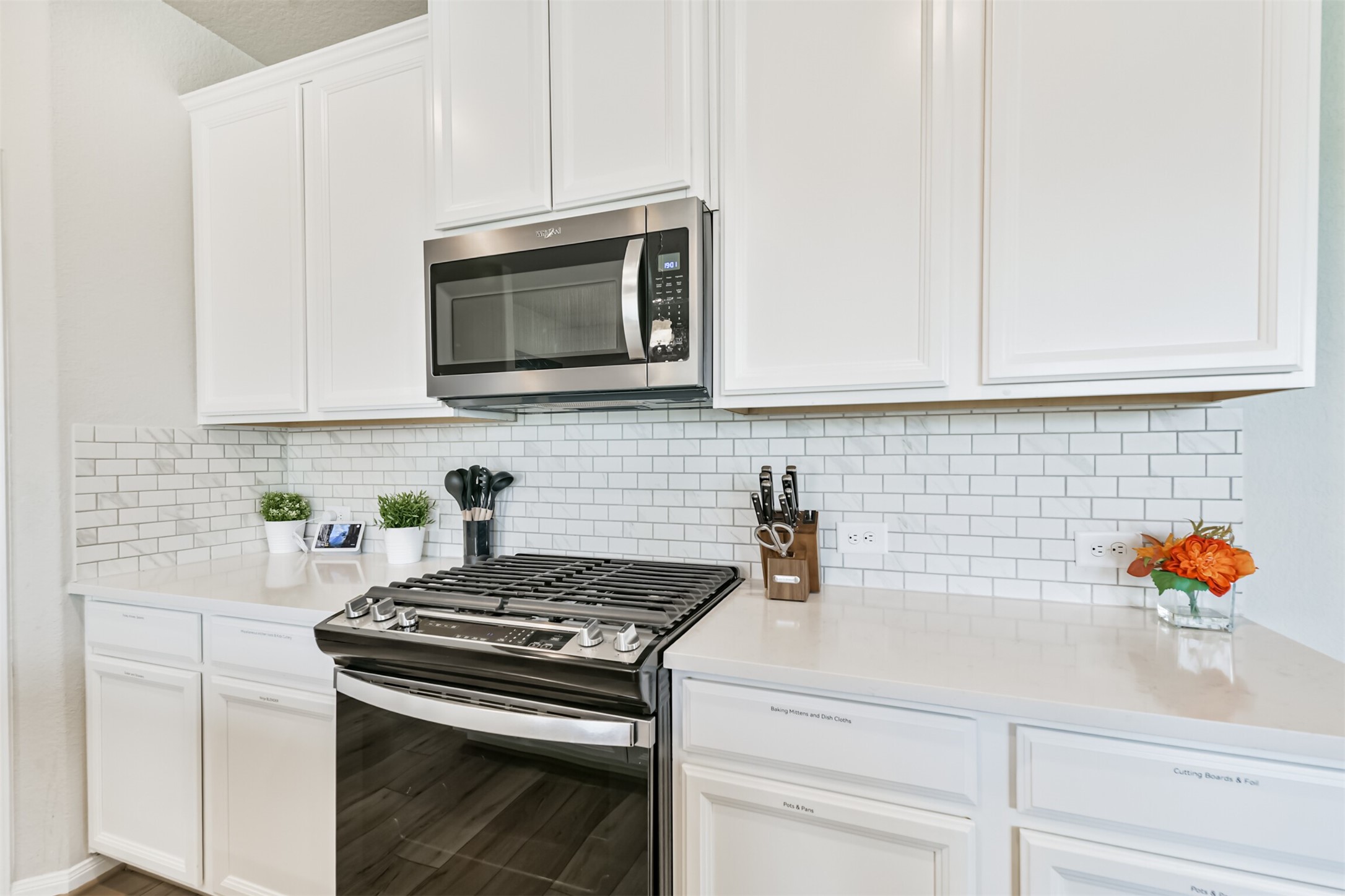 17465 Buckeye Branch Conroe, TX 77385 - Photo 11 of 47 This modern kitchen features sleek white cabinets with 5 Burner Gas Stove stainless steel appliances complete the contemporary look!