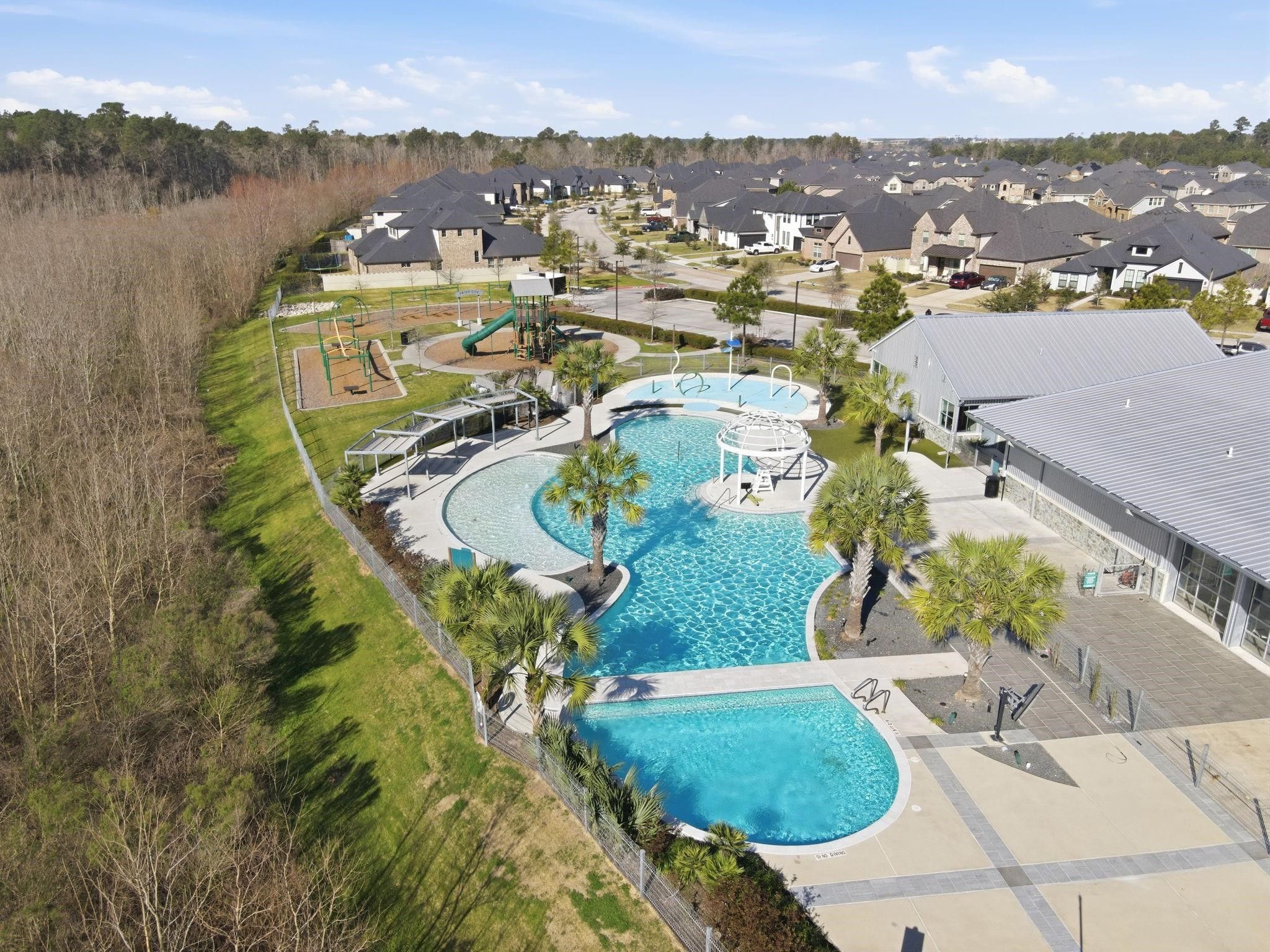 17465 Buckeye Branch Conroe, TX 77385 - Photo 40 of 47 Resort style pool, splash pad, and playground
