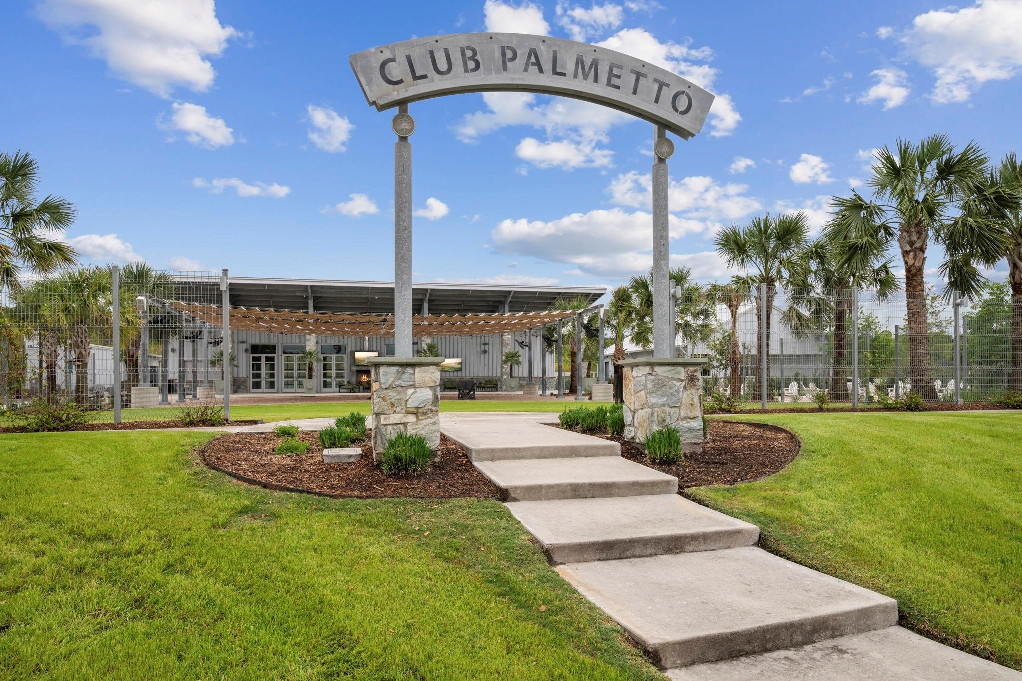 17465 Buckeye Branch Conroe, TX 77385 - Photo 46 of 47 This photo showcases the entrance to "Club Palmetto," a community facility surrounded by well-maintained lawns and palm trees, offering a welcoming and vibrant atmosphere for residents