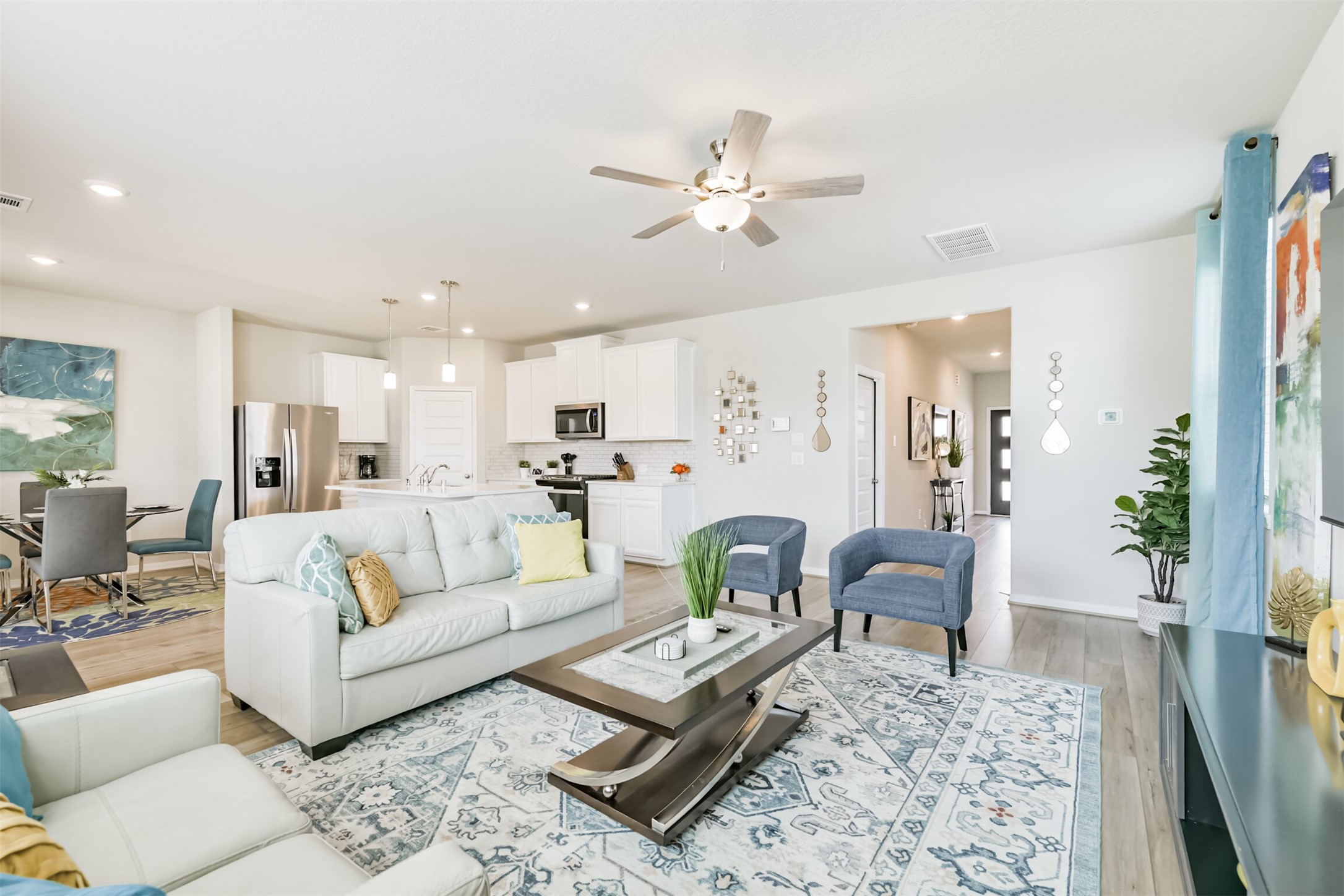 17465 Buckeye Branch Conroe, TX 77385 - Photo 6 of 47 This spacious open-concept living area features modern design with natural light, and a stylish kitchen with a breakfast bar. Perfect for entertaining and family gatherings.