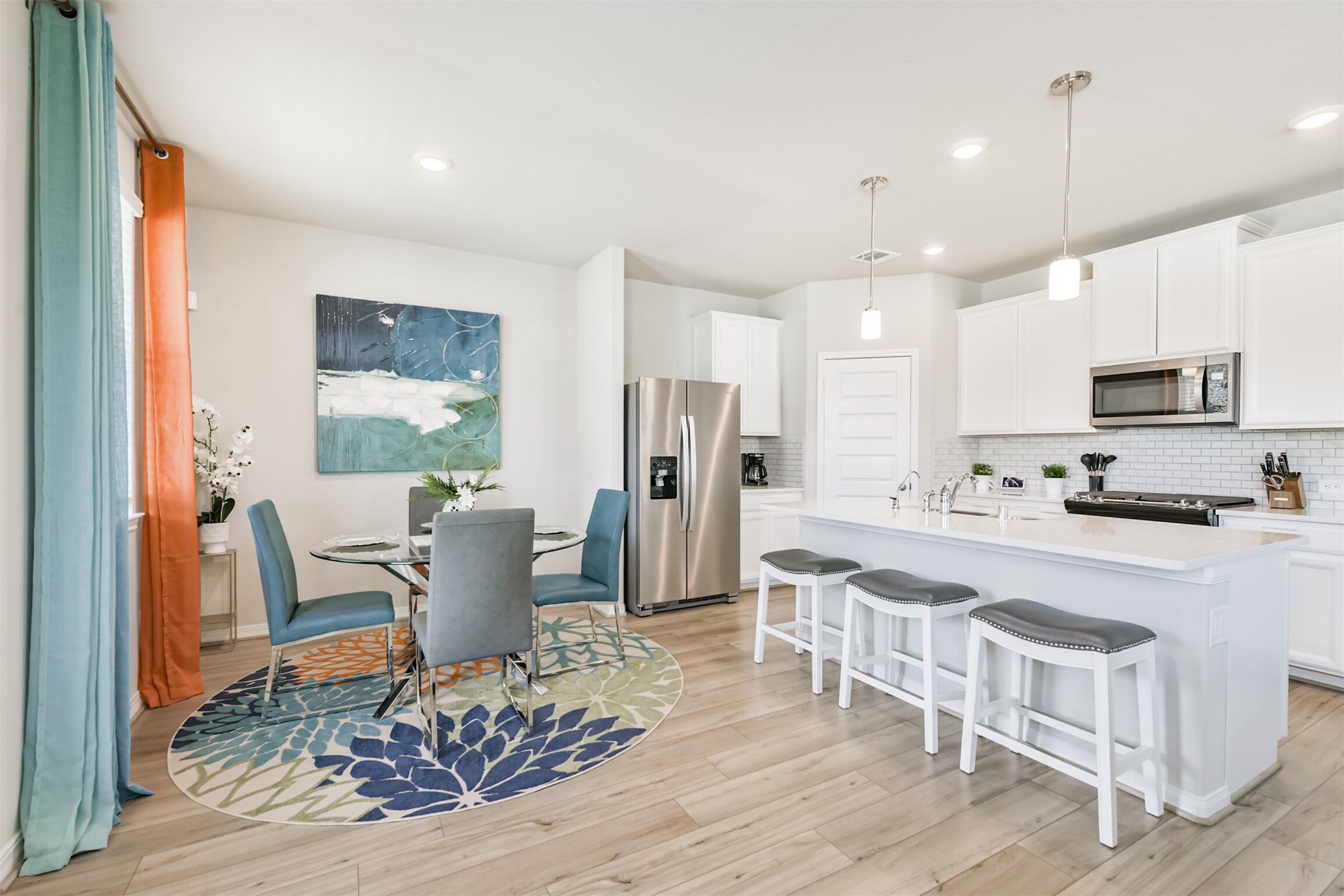 17465 Buckeye Branch Conroe, TX 77385 - Photo 7 of 47 Chef's kitchen featuring modern and stylish white cabinetry, quartz countertops, stainless steel appliances and contemporary backsplash