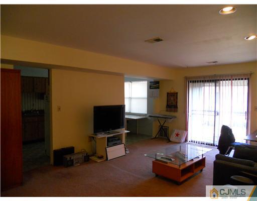 1624 Raspberry Court Edison, NJ 08817 - Photo 3 of 7 a living room with furniture a flat screen tv and a window