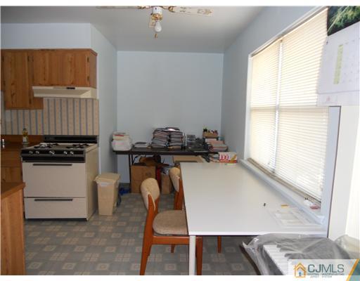 1624 Raspberry Court Edison, NJ 08817 - Photo 5 of 7 a view of a workspace with furniture and a window