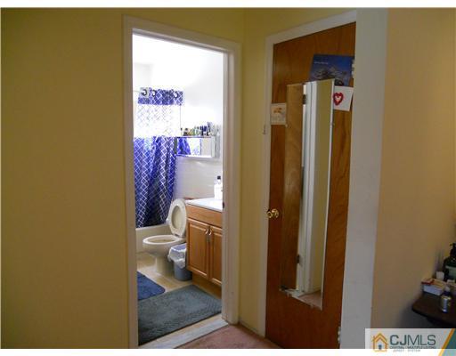 1624 Raspberry Court Edison, NJ 08817 - Photo 7 of 7 a bathroom with a toilet and a shower curtain