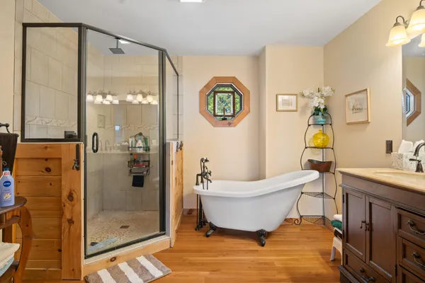 a spacious bedroom with a bed and a dresser