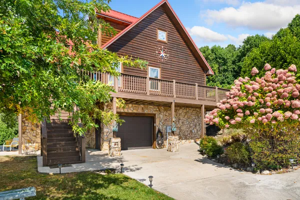 a front view of a house with yard and balcony