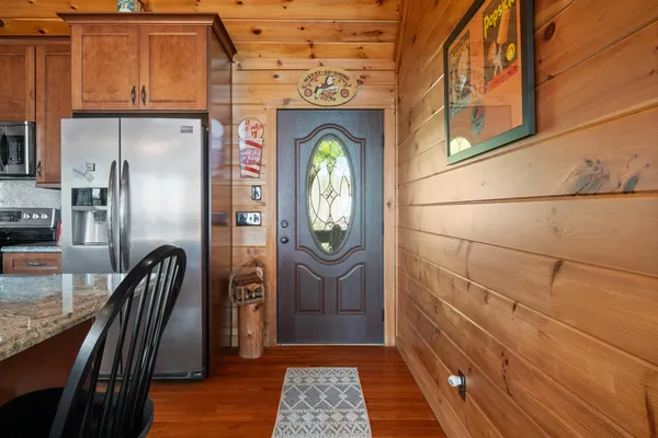 a kitchen with stainless steel appliances granite countertop a sink refrigerator and microwave