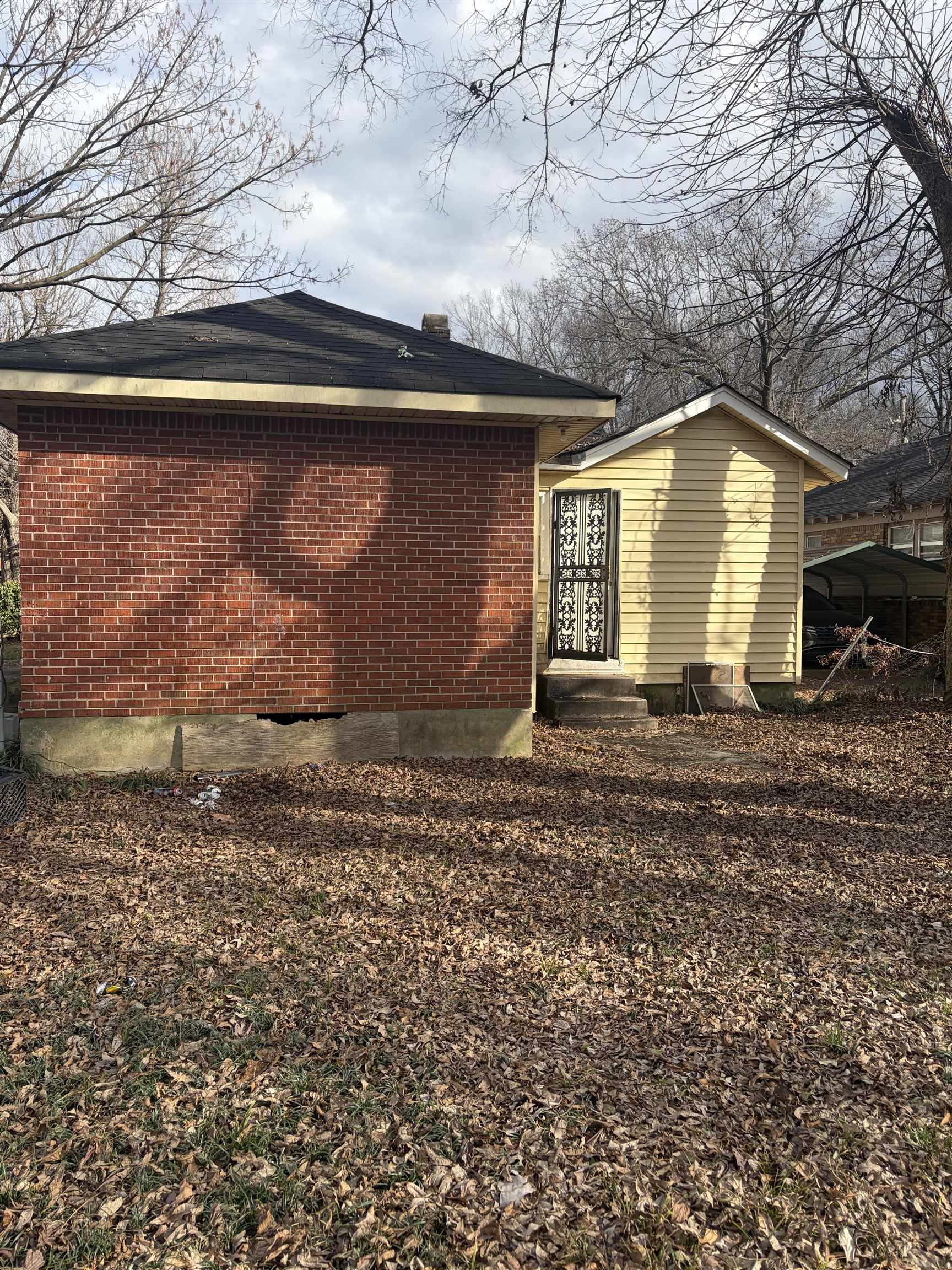 531 Lundee Street Memphis, TN 38111 - Photo 2 of 2 Rear view of house featuring entry steps, brick siding, and a chimney