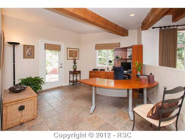 5610 Timpa Road Cascade, CO 80809 - Photo 7 of 16 Located just off the living area, this den/office area has tile floors and walk out to covered front patio