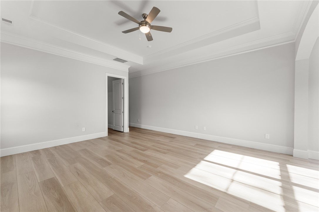 141 Rickys Path Easley, SC 29642 - Photo 20 of 40 This expansive bedroom offers elegant crown molding and ample natural light, ideal for peaceful living.