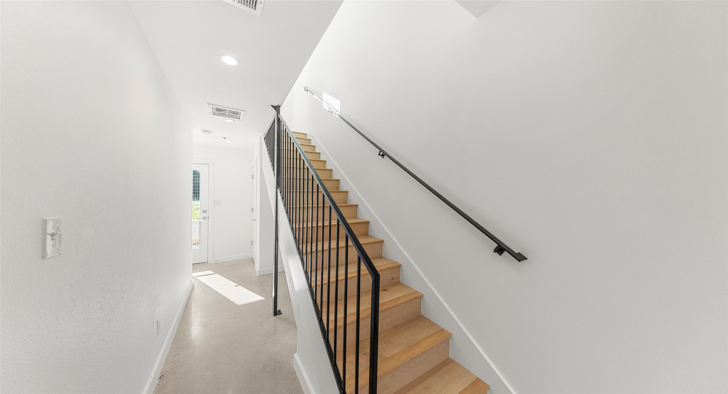 5912 Harold Court, Unit 106 Austin, TX 78721 - Photo 12 of 26 A light-filled stairwell connects the home's three levels, with clean lines and natural light that make everyday movement feel effortless. Model No. 104 Shown.