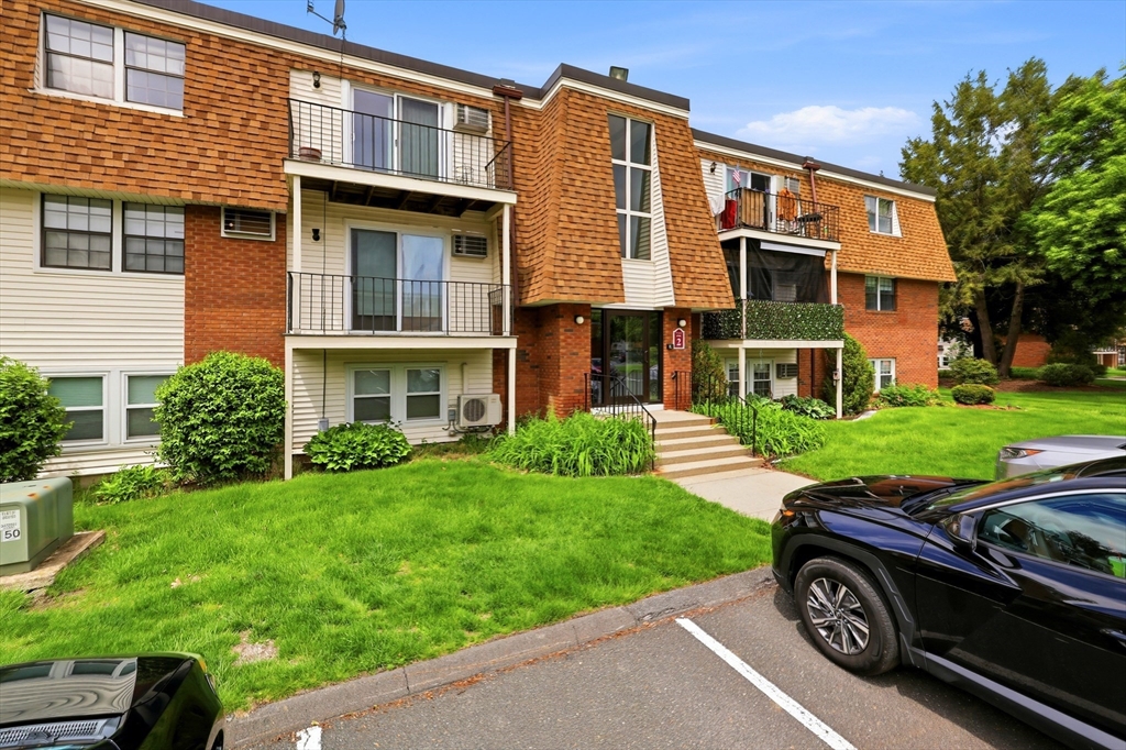 80 Damon Road, Unit 2303 Northampton, MA 01060 - Photo 2 of 23 a front view of a house with a yard